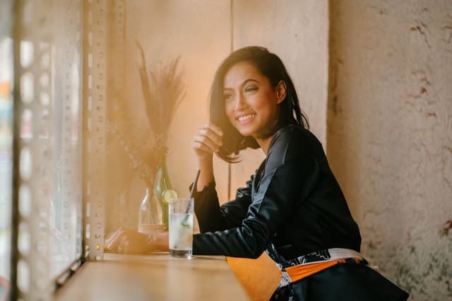 smiling women with drink at bar